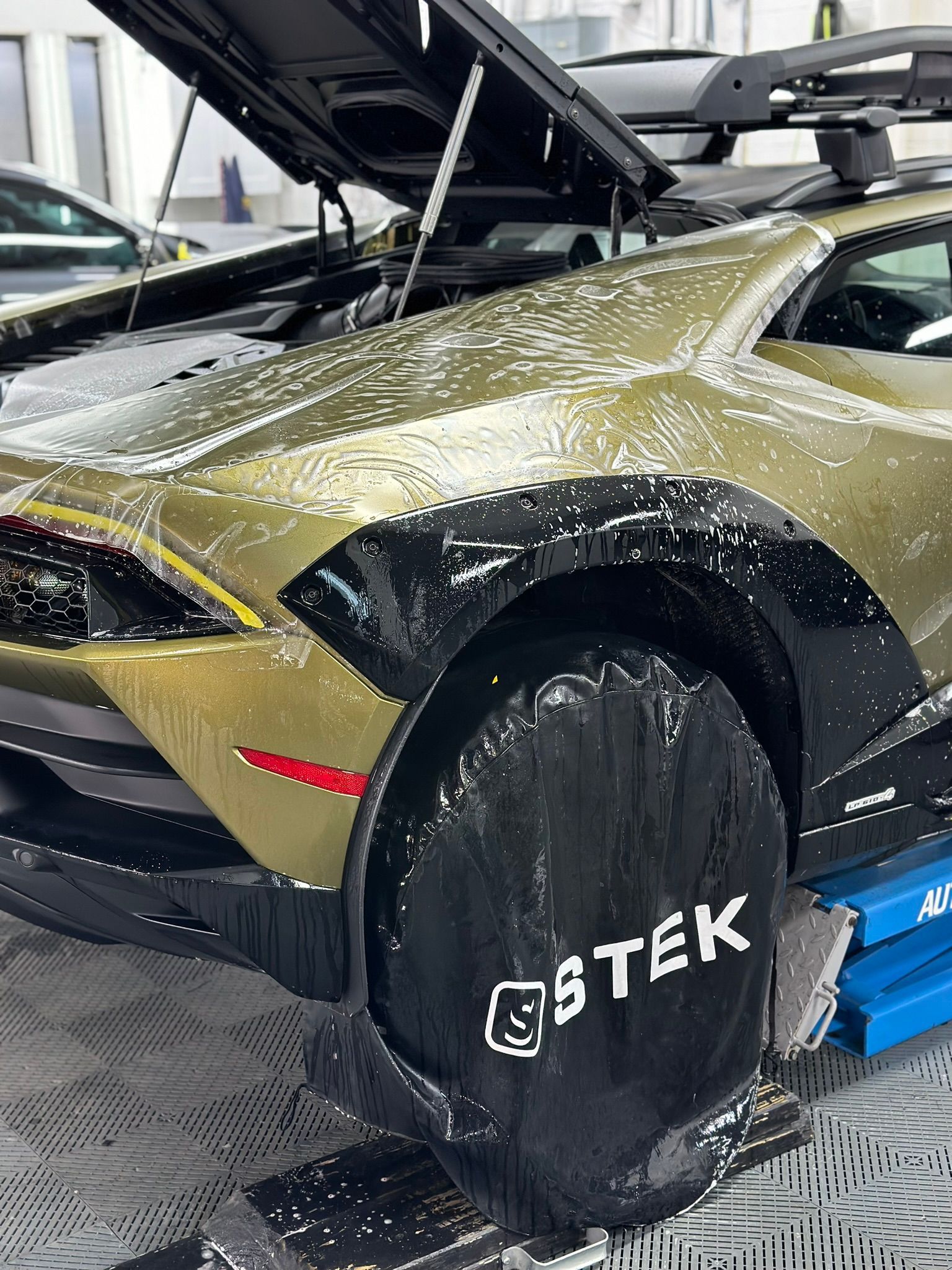 Gold Lamborghini Sterrato covered in soap suds after a ceramic coating maintenance wash